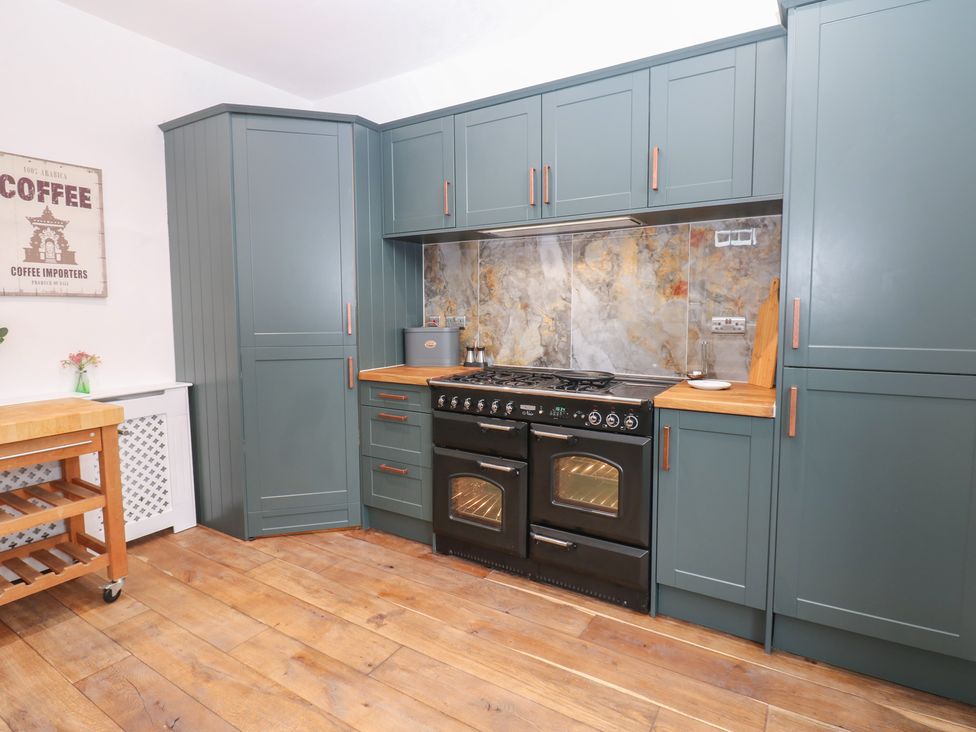 A kitchen with cabinets and a cooking range at Broadwath Old House in Heads Nook
