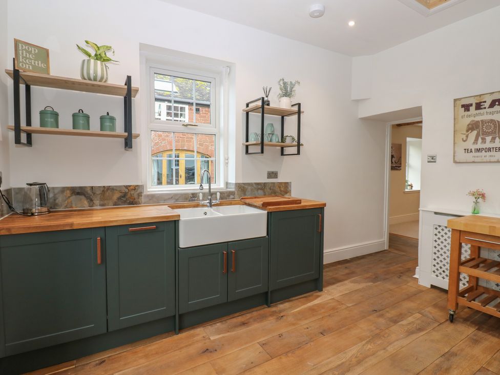 A kitchen with a sink and cupboards at Broadwath Old House in Heads Nook