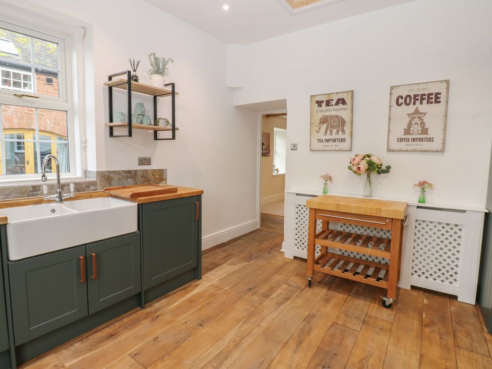 A kitchen with a sink and cabinets at Broadwath Old House in Heads Nook