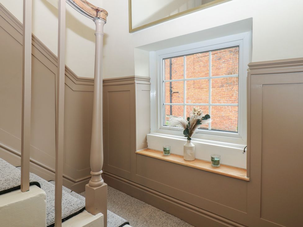 A staircase with a window and decorative items at Broadwath Old House in Heads Nook