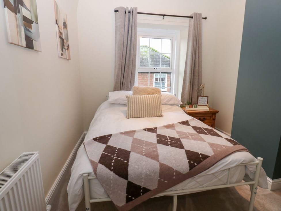 A bedroom with a bed and window at Broadwath Old House in Heads Nook