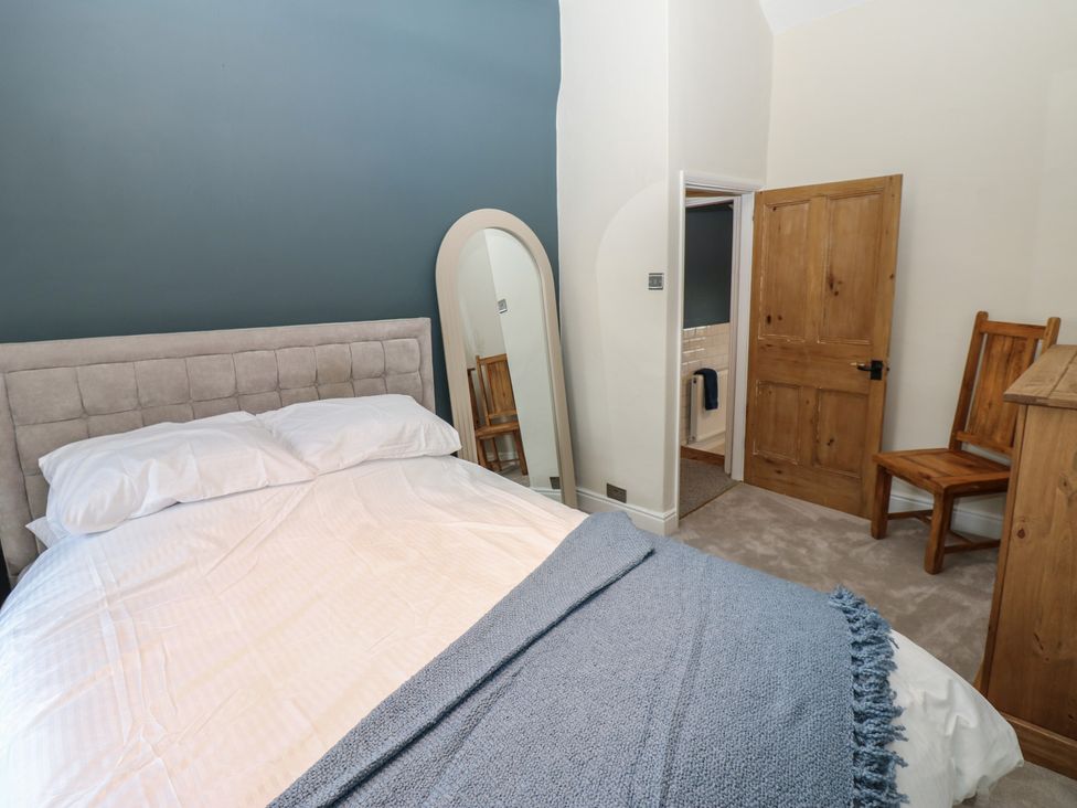 A bedroom with a bed and a chair at Broadwath Old House Heads Nook