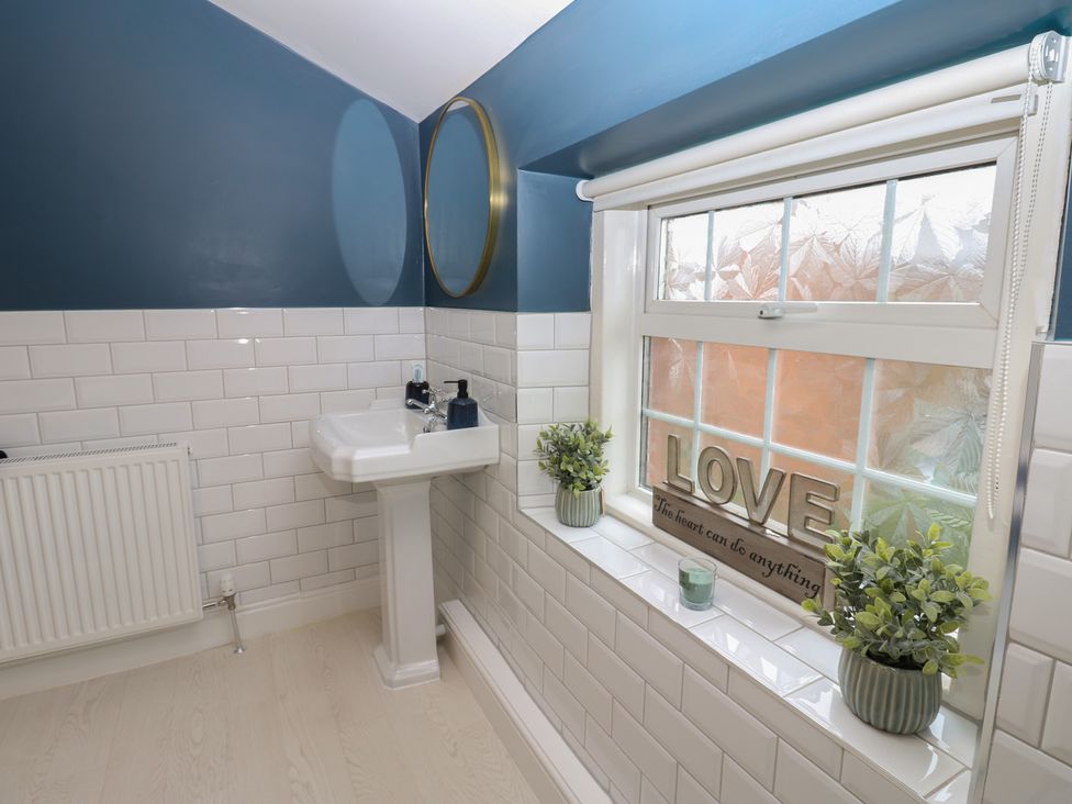A bathroom with a sink and mirror at Broadwath Old House in Heads Nook