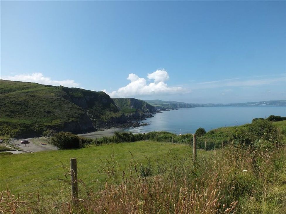A coastal view with cliffs and ocean at Dinas Island Cottage in Dinas Cross