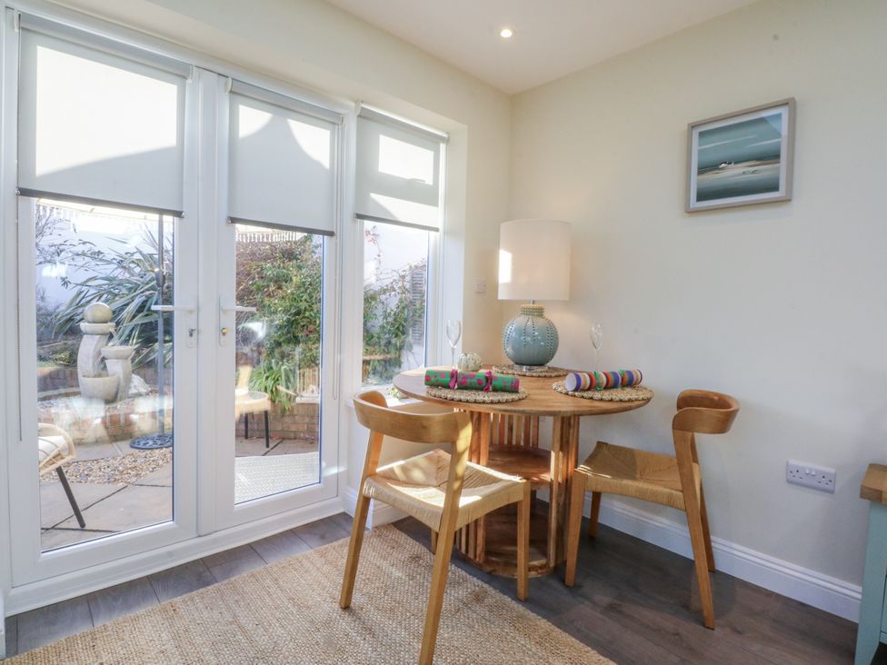 A dining area with a small table and chairs at The Summerhouse in Llandudno