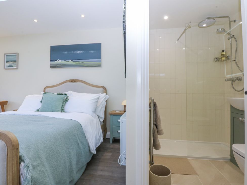 A bedroom with an ensuite shower area at The Summerhouse in Llandudno