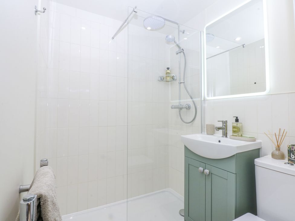 A bathroom with shower and vanity unit at The Summerhouse in Llandudno