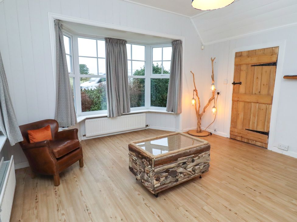 A snug with a chair and a table at Braeburn in Bamburgh