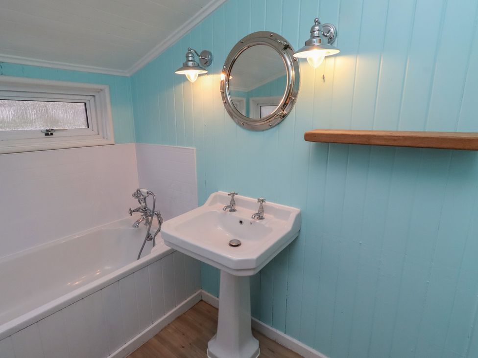 A bathroom with bathtub and sink at Braeburn in Bamburgh