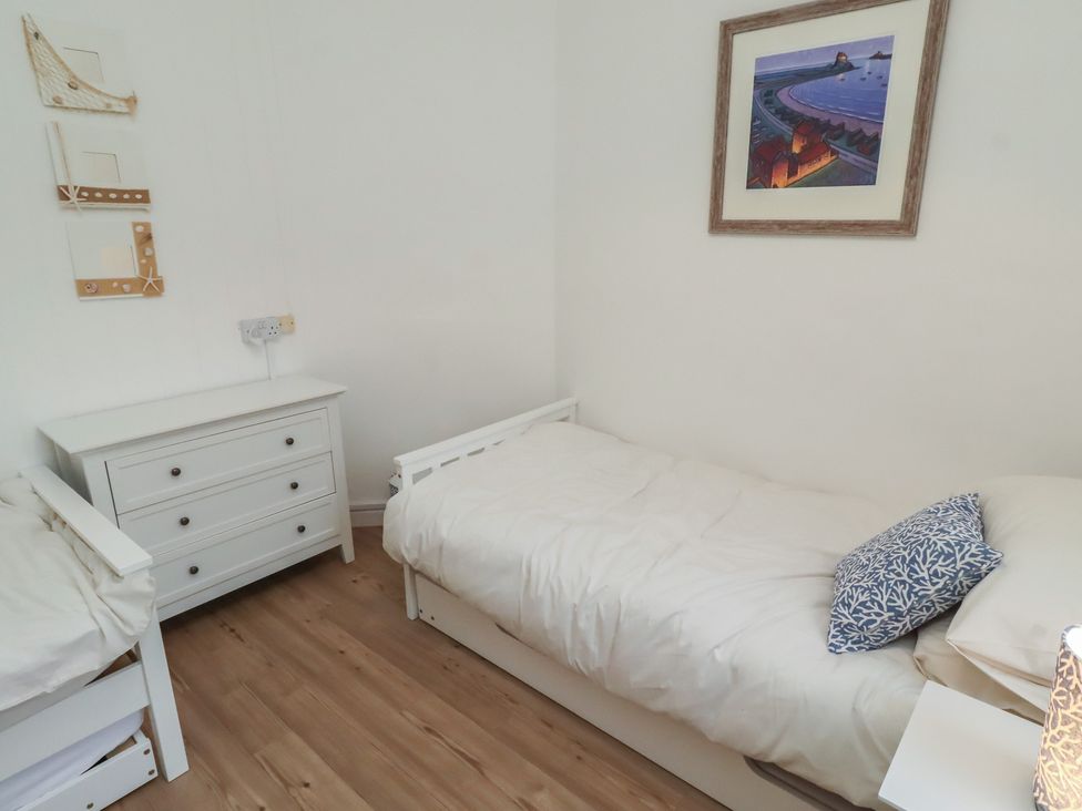 A bedroom with two beds and a drawer unit at Braeburn in Bamburgh