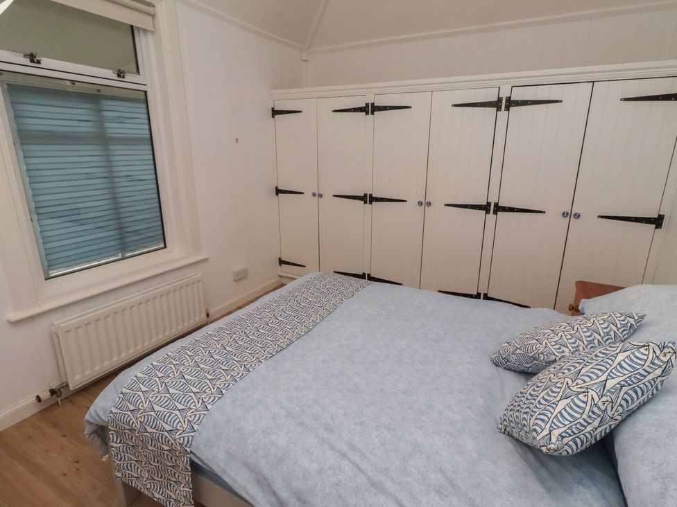 A bedroom with a bed and cupboards at Braeburn in Bamburgh
