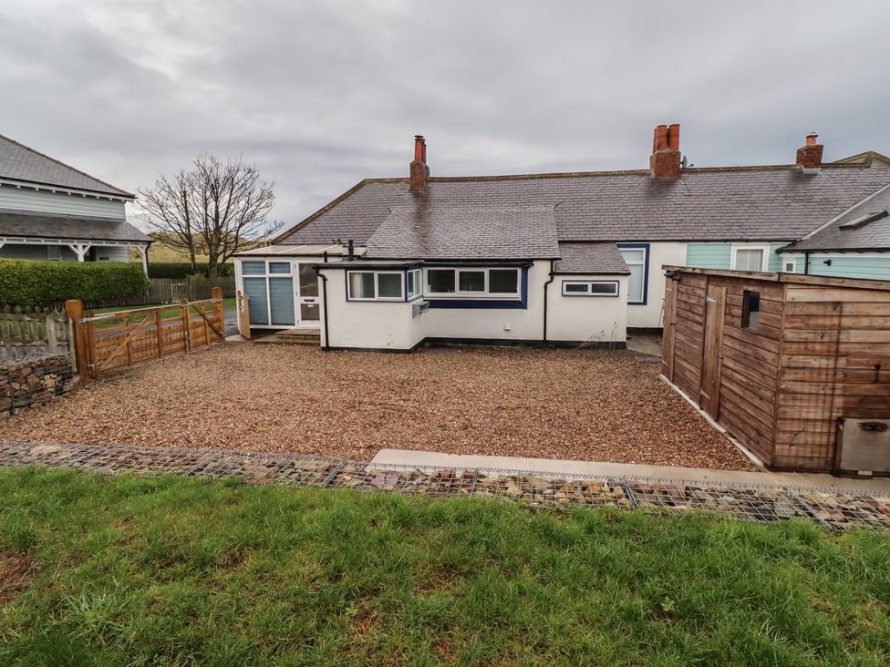 A house with a gravel garden and a shed at Braeburn in Bamburgh
