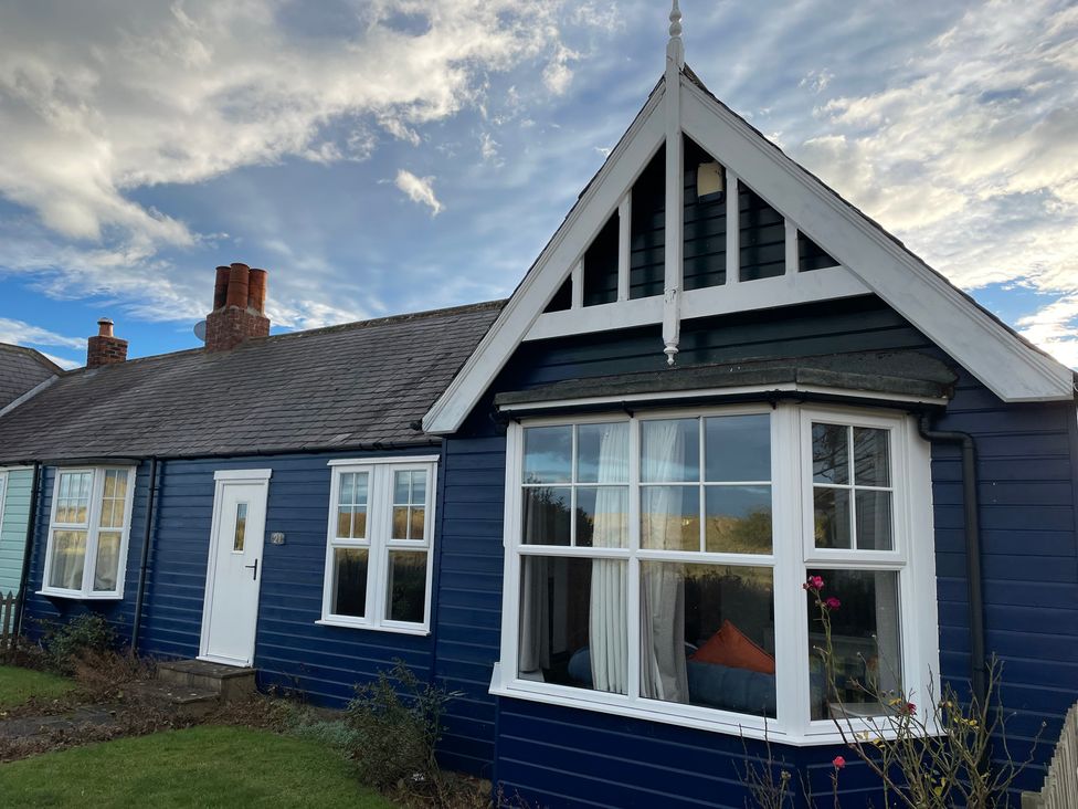 A house exterior with windows and a garden at Braeburn in Bamburgh