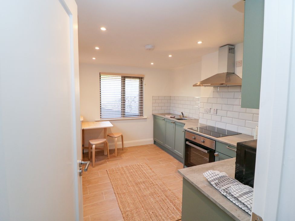 A kitchen with table and chairs at Duck Cottage 