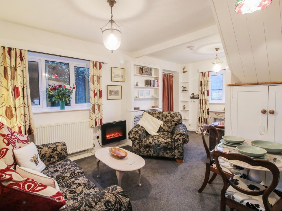 A living room with sofa and table at Bumble Bee at 2 Clematis Cottage near Clee Hill