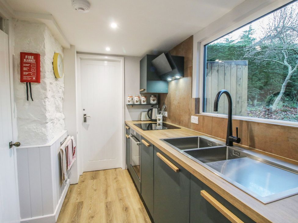 A kitchen with a sink, kettle and cupboard at Bumble Bee at 2 Clematis Cottage near Clee Hill