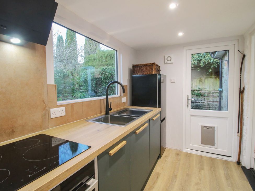 A kitchen with a sink and induction cooktop at Bumble Bee at 2 Clematis Cottage near Clee Hill