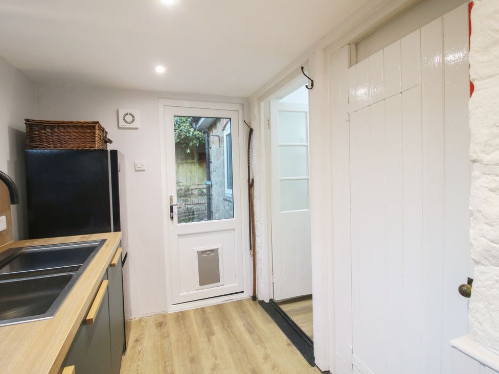 A kitchen with a refrigerator and sink at Bumble Bee at 2 Clematis Cottage near Clee Hill