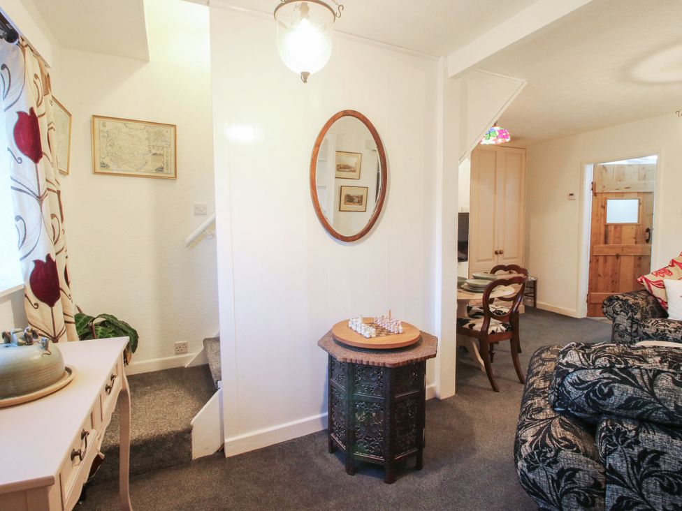 A hallway with a mirror and a chess board at Bumble Bee at 2 Clematis Cottage near Clee Hill