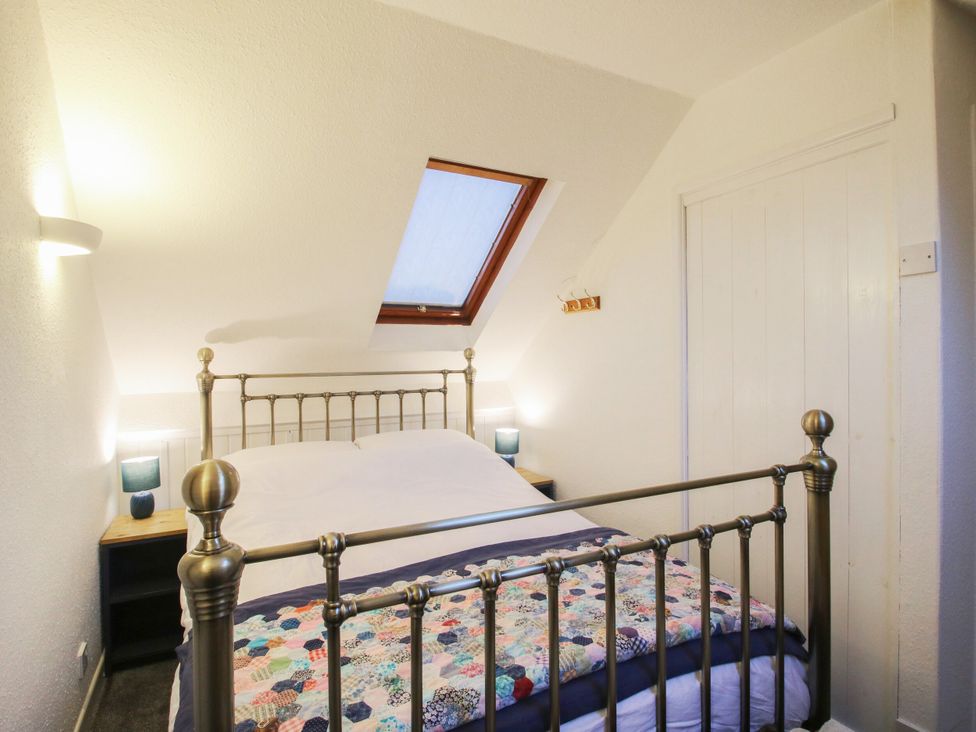 A bedroom with a bed and bedside tables at Bumble Bee at 2 Clematis Cottage near Clee Hill