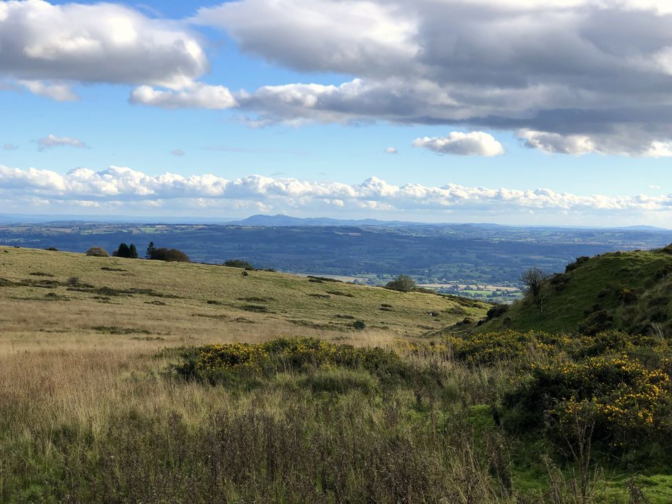 A view of hills and landscape in the distance at Bumble Bee at 2 Clematis Cottage near Clee Hill