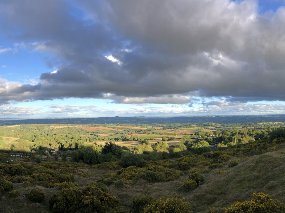 A scenic view of hills and fields at Bumble Bee at 2 Clematis Cottage near Clee Hill