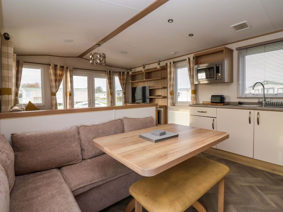 A living room with a sofa and table at The Drift in High Skirlington near Skipsea