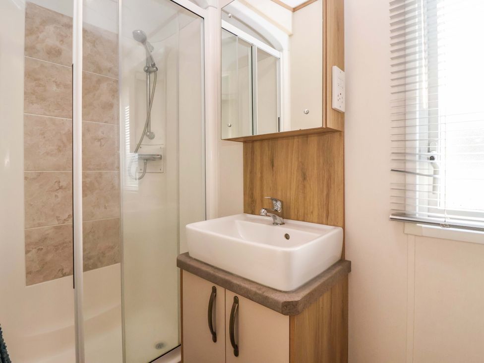 A bathroom with a shower and a sink at The Drift in High Skirlington near Skipsea