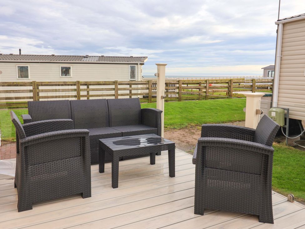 A seating area with a table and chairs at The Drift near High Skirlington near Skipsea