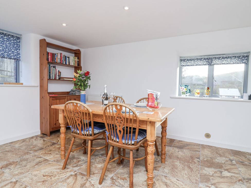 A dining room with a table and four chairs at Dairy Cottage Bullhornstone near South Brent