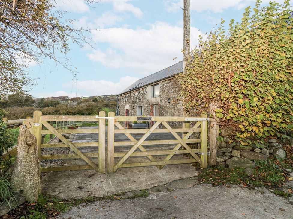 An entrance gate leading to a stone building at Dairy Cottage Bullhornstone near South Brent