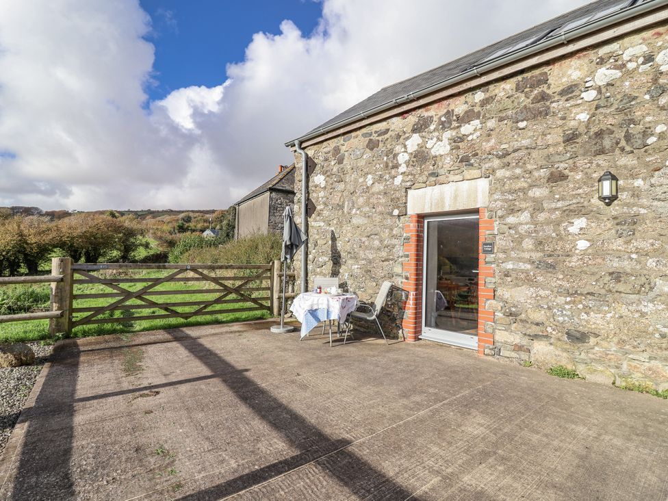 An outdoor seating area with a table and chairs at Swallow Cottage Bullhornstone near South Brent