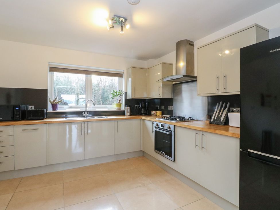 A kitchen with modern appliances and window at Lurach House in Port Appin