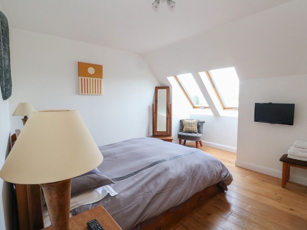 A bedroom with a bed and television at Lurach House Port Appin