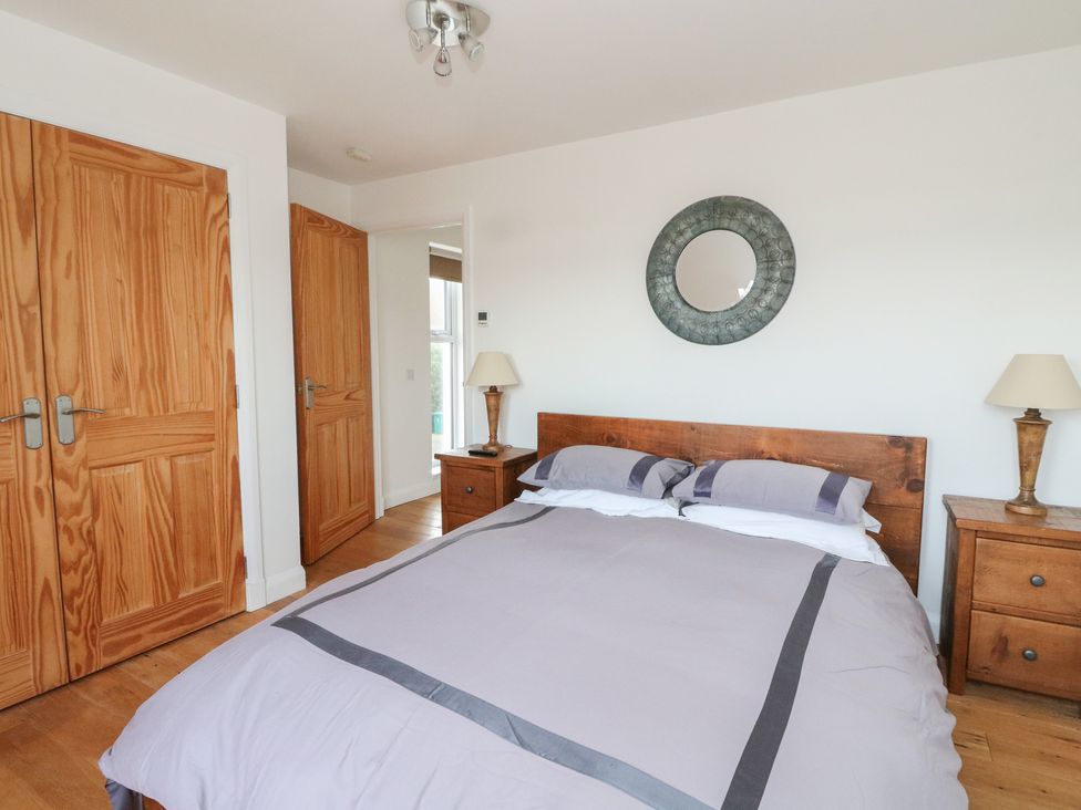 A bedroom with a bed and bedside tables at Lurach House Port Appin