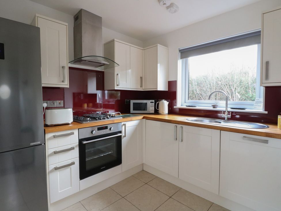 A kitchen with a refrigerator, oven, sink and window at Sealladh in Appin