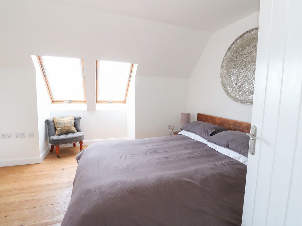 A bedroom with a bed and side table at Sealladh in Appin
