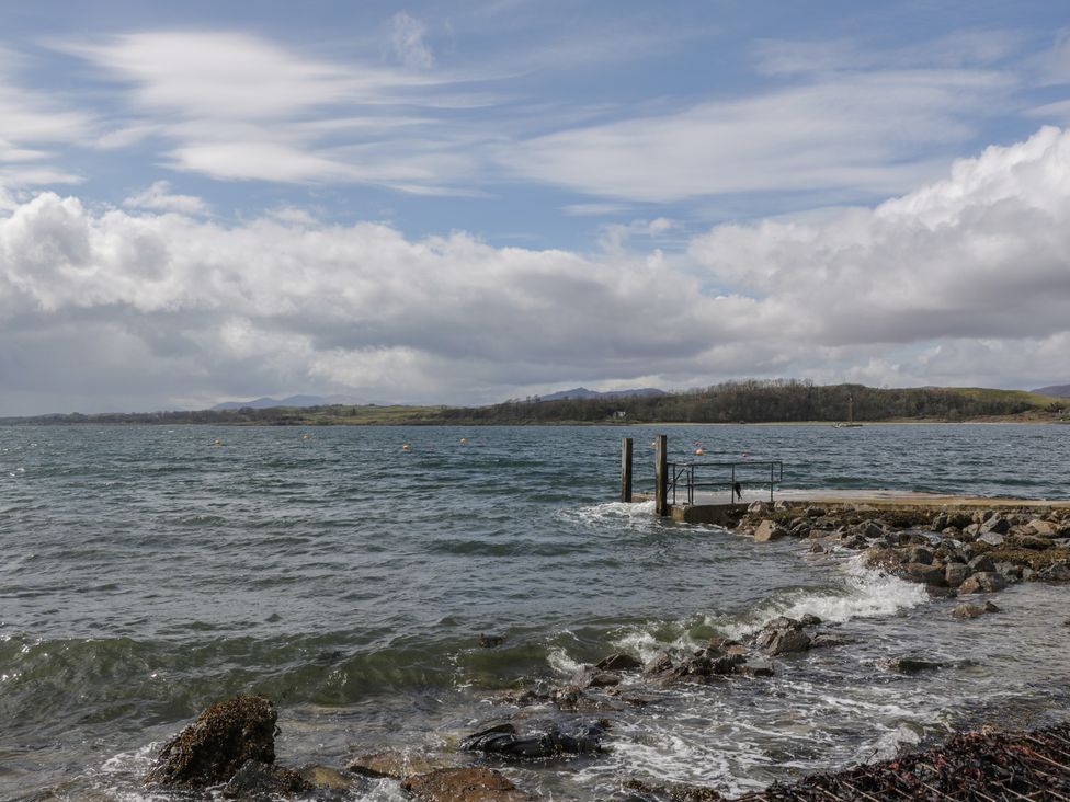 A view of water with a pier and rocks at Sealladh in Appin