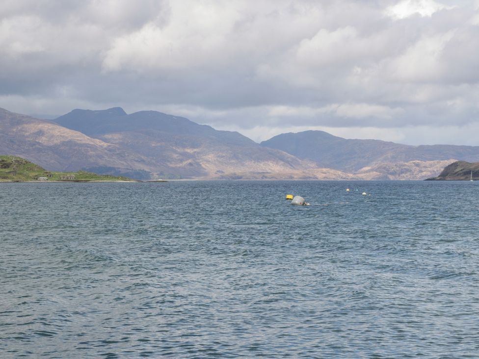 A view of water with mountains and buoys at Sealladh in Appin