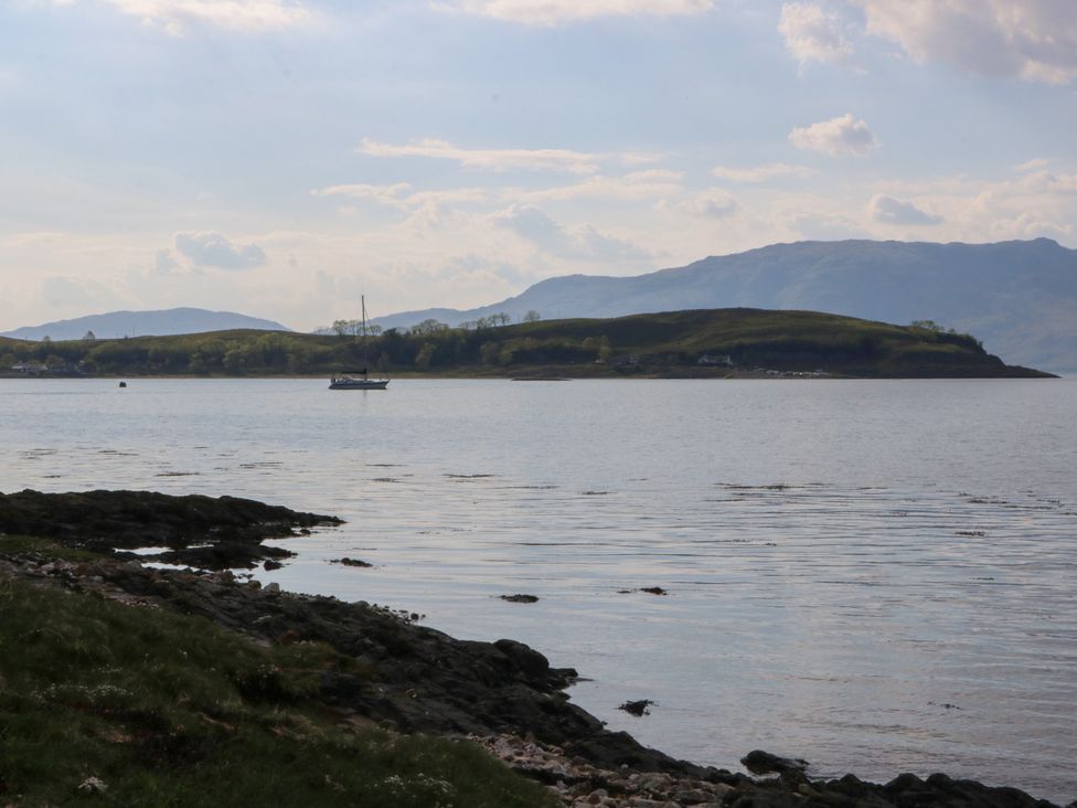 A view of an island and mountains across the water at Sealladh in Appin