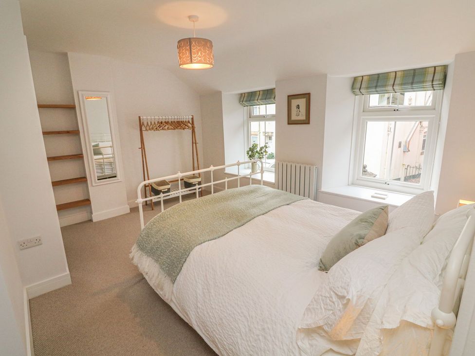 A bedroom with a bed and shelves at The Old Workshop in 