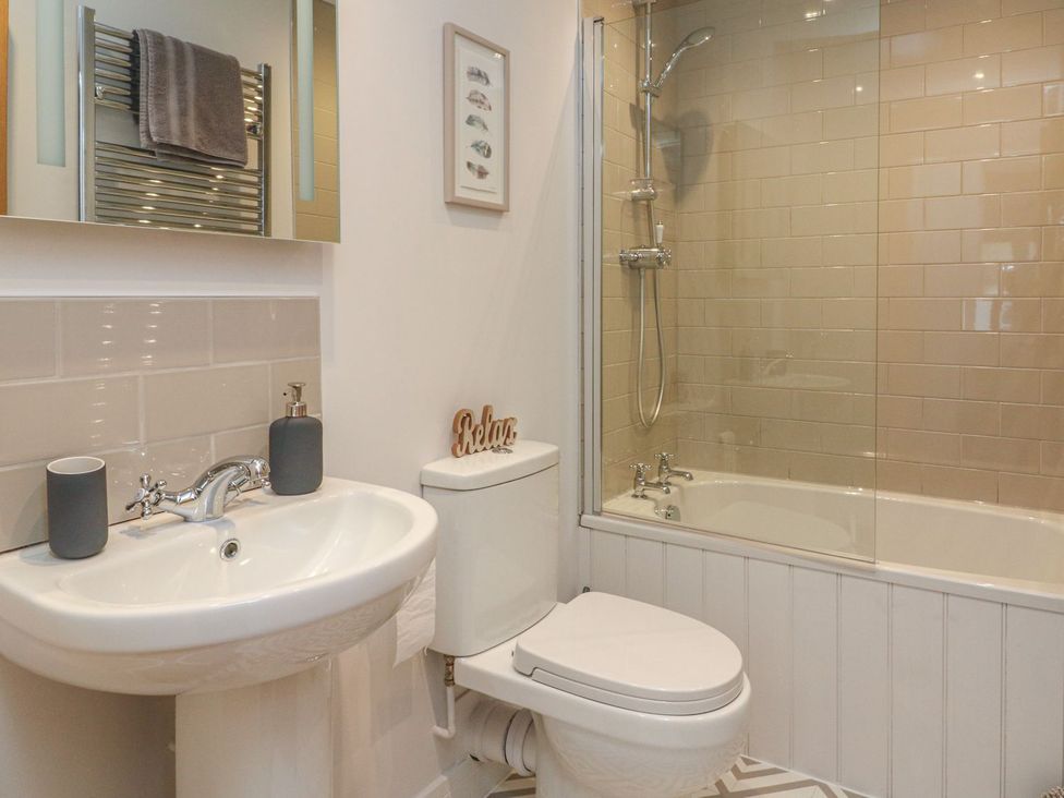 A bathroom with a sink and shower at The Old Workshop in 