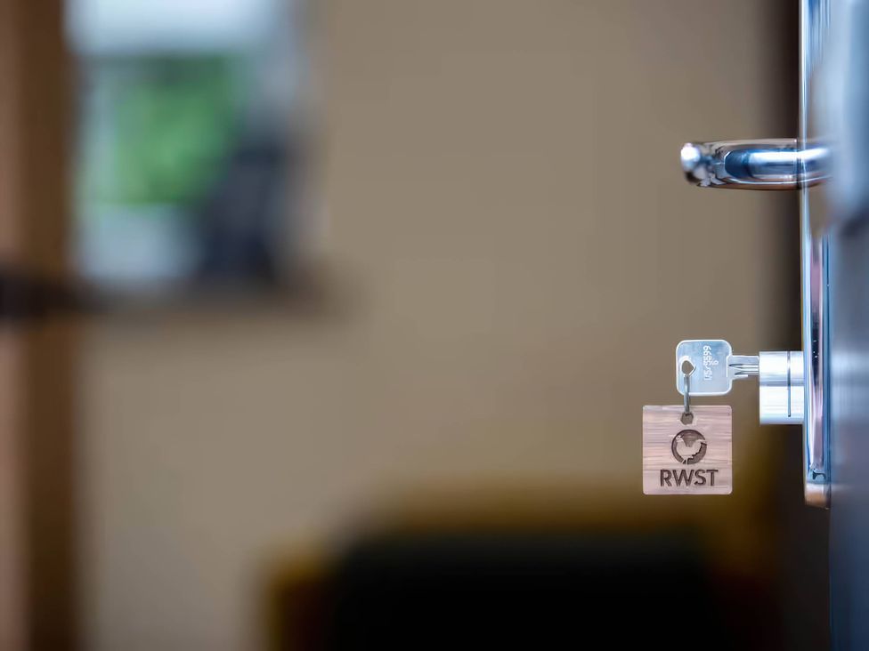 A door handle with a key and key tag at Oakwood Apartment, Llanrwst