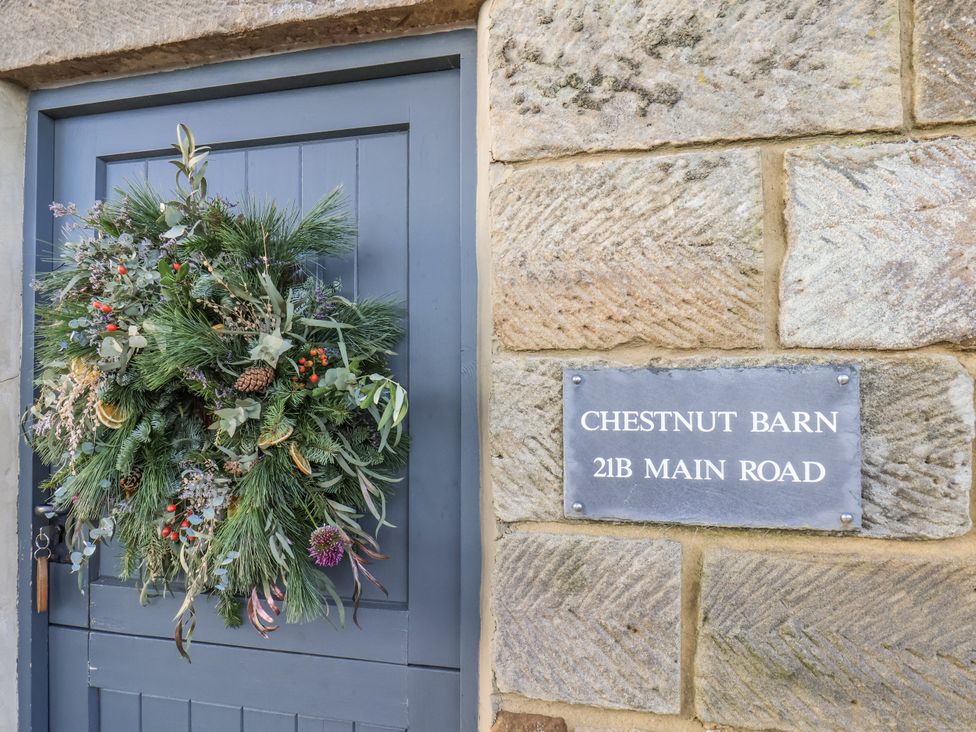 An entrance with a decorative wreath and a nameplate at Chestnut Barn Aislaby near Whitby