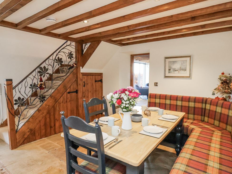 A dining room with a table set for meals at Chestnut Barn Aislaby near Whitby