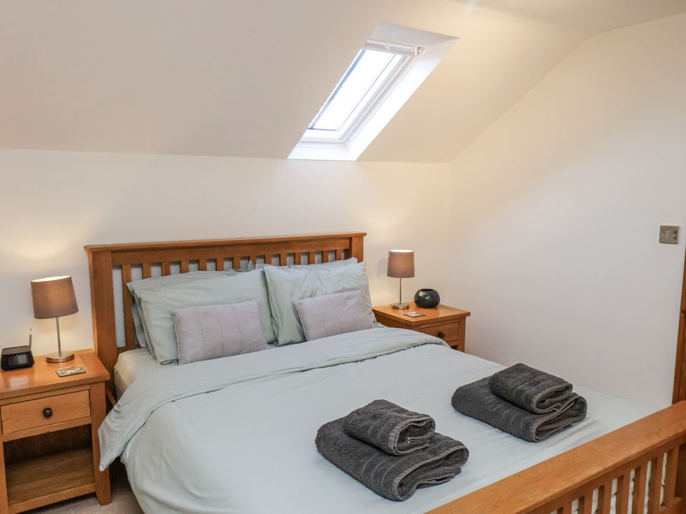 A bedroom with a bed and bedside tables at Chestnut Barn Aislaby near Whitby
