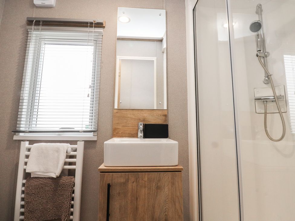 A bathroom with a sink and a shower at The Retreat in Morecambe