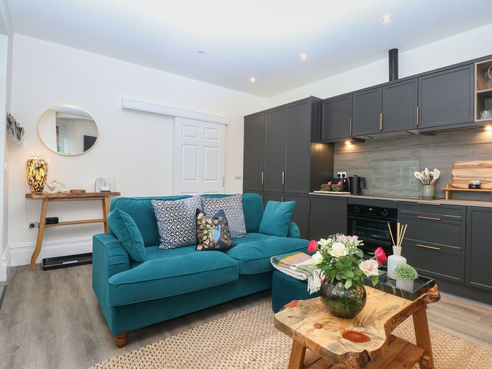 A living room with a sofa and coffee table at The Magnolia in Rhos-On-Sea