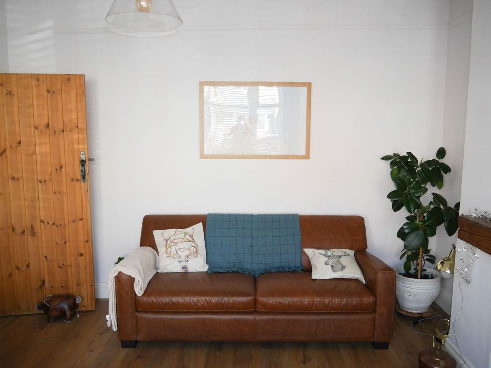 A living room with a sofa and a picture frame at Anchor Cottage in Cleethorpes