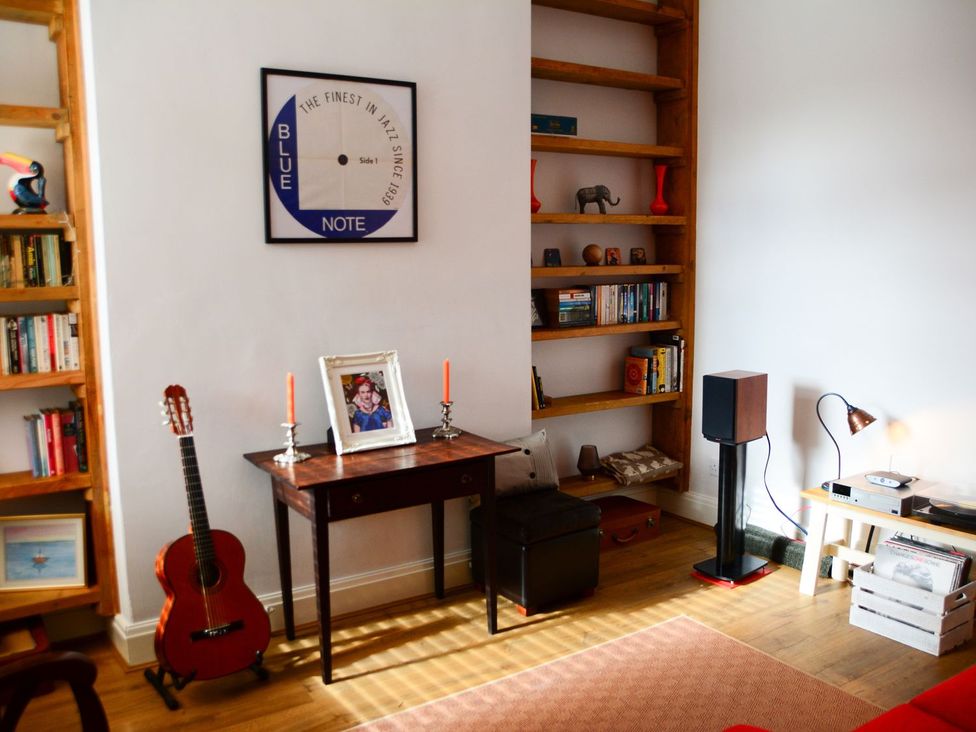 A living room with a bookshelf and a desk at Anchor Cottage in Cleethorpes